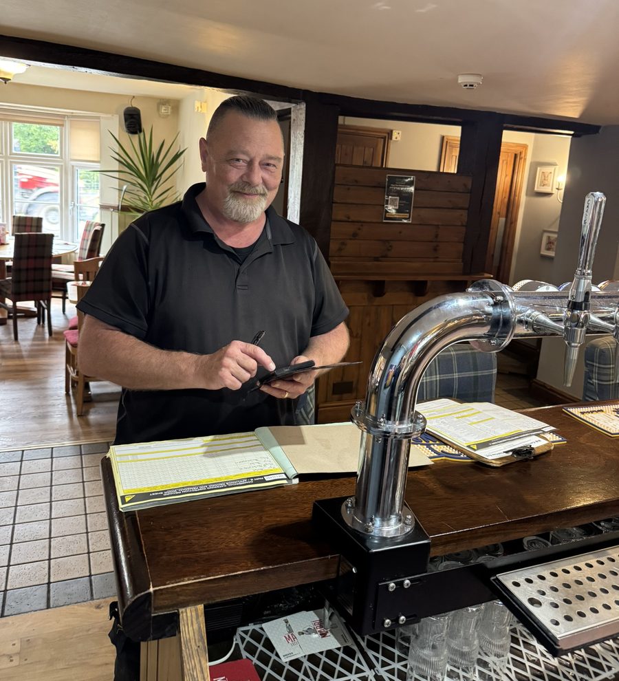 Richard, commercial kitchen engineer, at a pub bar with paperwork